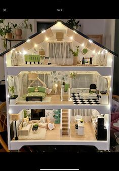 a doll house with lights and furniture inside