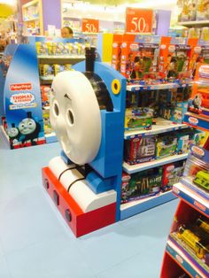 thomas the tank engine toy on display in a toys r us store with children's bookshelves