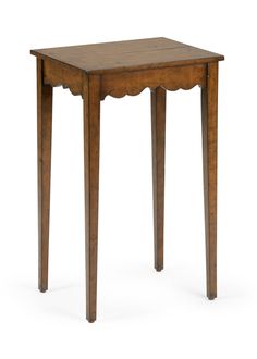 a small wooden table with scalloped legs