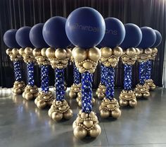 blue and gold balloons are on display at an event