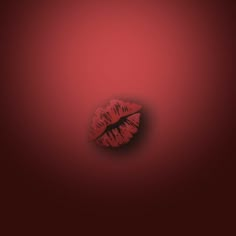 a red wall with a lipstick imprint on the bottom and one lip in the middle