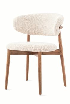 an upholstered chair with wooden legs and a white fabric seat pad on the back