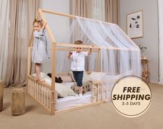 two children standing on top of a wooden bed