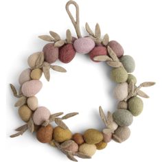 a wreath made out of felt balls and leaves