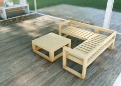 two wooden benches sitting on top of a wooden deck