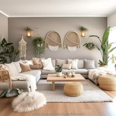 a living room filled with lots of furniture and plants on the wall above it's coffee table