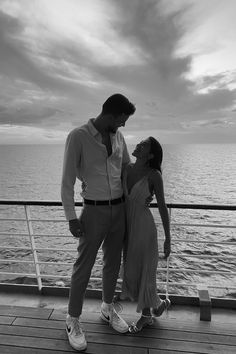 a man standing next to a woman on top of a boat