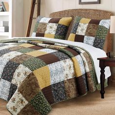 a bed with a brown and white quilt on it