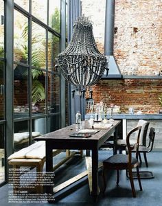 a dining room table with chairs and a chandelier hanging from the ceiling