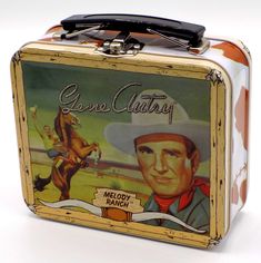 an old tin lunch box with a cowboy on it