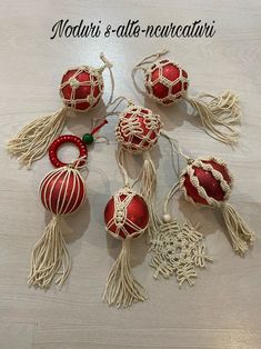 several red and white ornaments on a table with the words mottari's alto - nevecatini written in italian