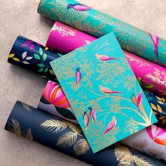 many different colored wrapping paper on top of each other