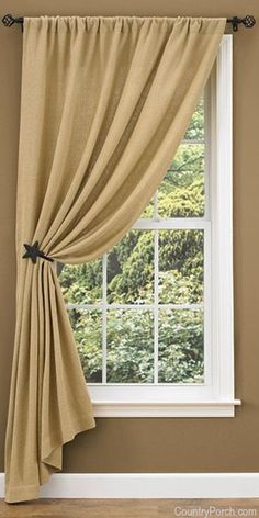 a window with a curtain hanging on the side of it