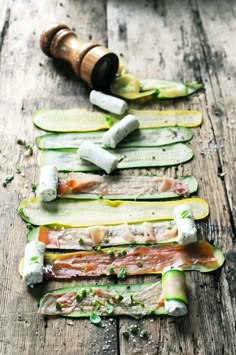 cucumber slices are arranged in the shape of an arrow with herbs on them