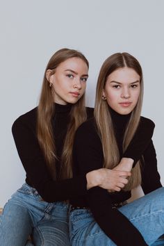 two young women sitting next to each other