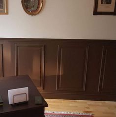 a table with a toaster on it in front of a brown paneled wall