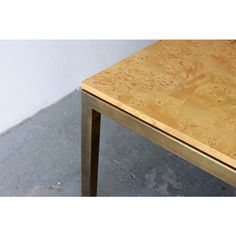 a wooden table sitting on top of a cement floor