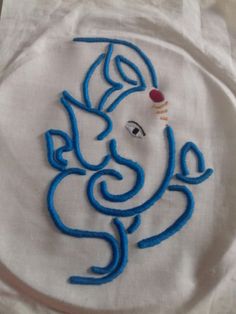 an elephant embroidered onto a white cloth with blue thread on the face and back side