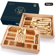 two boxes filled with gold colored forks and spoons