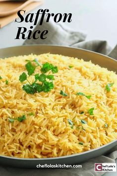 a pan filled with rice and parsley on top of a table