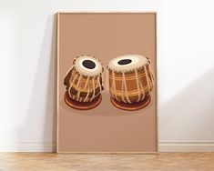 a poster with two drums on it in front of a white wall and wooden floor