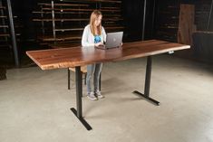 a woman sitting at a table using a laptop computer