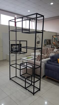 a living room filled with furniture next to a white tiled floor covered in lots of windows