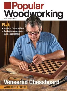 the cover of popular woodworking magazine shows a man playing chess on a wooden table