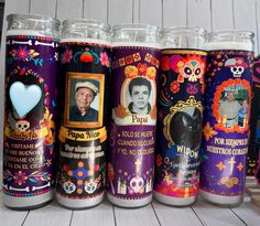 several different colored cans with pictures and skulls on the sides, all lined up in a row