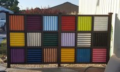 there is a multicolored fence made out of shipping containers