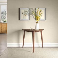 a vase with yellow flowers sitting on top of a wooden table next to a window