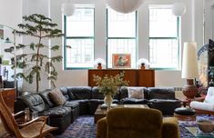 a living room filled with furniture and lots of windows