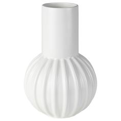 a white vase sitting on top of a table