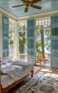 a bedroom with blue shutters and a bed