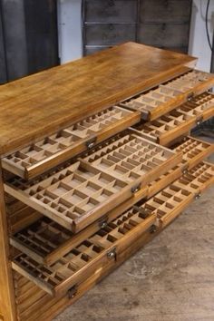 an old wooden table with drawers on the bottom and one drawer open to show parts