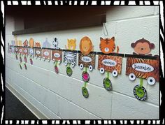 the wall is decorated with many different animals and name tags on each piece of paper