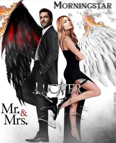 a man and woman standing next to each other in front of an angel wings poster