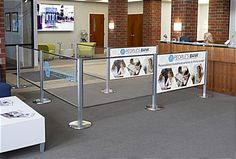 an office lobby with glass railings and signs