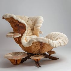 an unusual chair and footstool made out of wood with white fabric on it