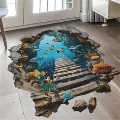 an underwater scene is shown on the floor in this room with wooden planks and fish