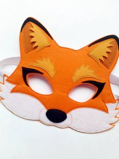 an orange fox mask on a white background