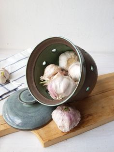 some garlic is in a bowl on a cutting board