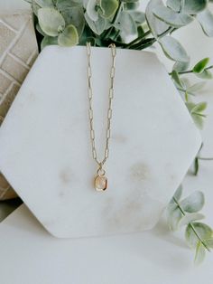 Take your style to the next level with the Aria Necklace! This chic and elegant statement accessory features a 16K gold filled baguette multifaceted natural gemstone charm, hanging from a paperclip chain. Details - Gold filled chain, about 17.8 inches in length - Gold filled pendant, about 12.8mm x 6.7mm in size - Lead Free, Nickel Free Paperclip Necklace With Charm, Paperclip Necklace, Business Photoshoot, Chic And Elegant, Smokey Quartz, Jewelry Case, Gold Filled Chain, Paper Clip, Stationery Notebook