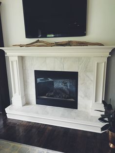 a fireplace with a flat screen tv above it