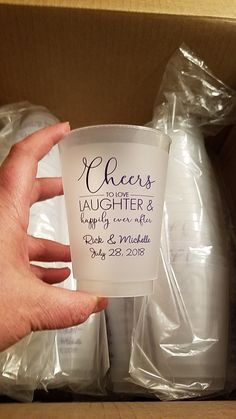 a person holding up a cup that says cheers laughter and happily come with dad and grandma