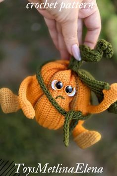 a hand holding an orange stuffed animal with eyes on it's head and the caption says, crochet pattern