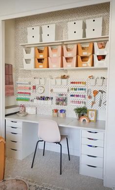 a white desk with lots of crafting supplies on top of it and storage bins