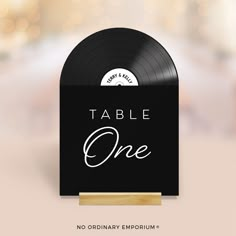 a black record box with the words table one on it and a wooden stand in front