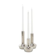 three silver candles sitting on top of each other