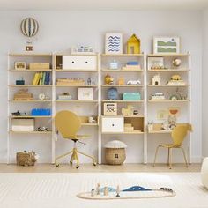 a room with shelves, chairs and toys on the floor in front of a bed